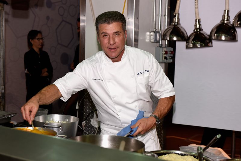 NEW YORK, NY - OCTOBER 16: Chef Michael Chiarello prepares food at Delta Presents Food with Altitude featuring Michael Chiarello, Michelle Bernstein, Linton Hopkins, Andrea Robinson and Jean-Paul Bourgeois during the Food Network New York City Wine & Food Festival Presented By FOOD & WINE at Union Square Events Kitchen on October 16, 2014 in New York City. (Photo by Dave Kotinsky/Getty Images for NYCWFF)