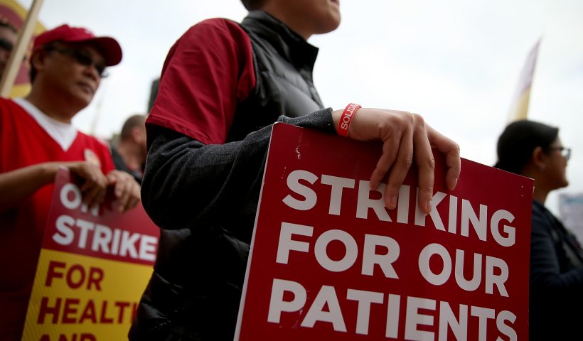 Nurses carry signs as they strike outside of Kaiser Permanente hospital on November 11, 2014 in San Francisco, California. Nearly 18,000 Kaiser Permanente nurses in Northern California are staging a two-day strike amidst contract negotiations and to demand better working conditions, training and optimal safeguards for treating ebola. (Photo by Justin Sullivan/Getty Images)