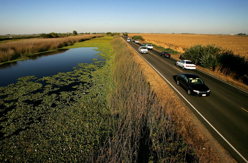 STOCKTON, CA - SEPTEMBER 28: Water is held back from a lower-elevation farm (R) by a section of Highway 4 that serves as a levee road in the Sacramento-San Joaquin River Delta, on September 28, 2005 west of Stockton, California. Officials say that the dikes of the Sacramento-San Joaquin River Delta are in worse shape than those that broke and flooded New Orleans during Hurricane Katrina. There is a two-in-three chance that a catastrophic earthquake or storm in the next 50 years will damage the levees enough to cause the kind destruction that engulfed New Orleans, according to experts. Such an event would affect the water supply that serves two-thirds of California and create a nightmare traffic jam on Highway 4, the two-lane road that would be the major evacuation route, if it is not damaged beyond usability. 1,600 miles of levees protect the delta?s islands, which lie well below sea-level, and most were built more than 100 years ago. (Photo by David McNew/Getty Images)