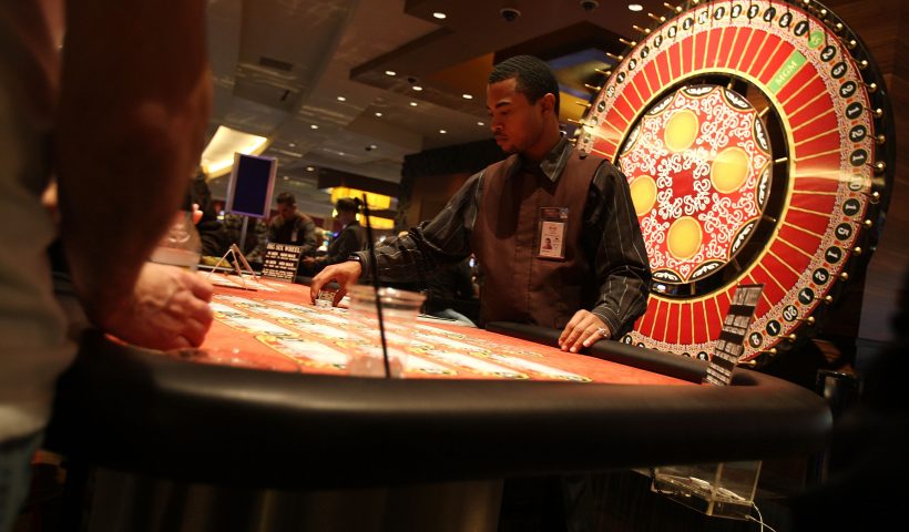 DETROIT - NOVEMBER 19: A dealer hands out chips at a table at a casino November 19, 2008 in Detroit, Michigan. With the Detroit auto manufactures in decline, the gaming industry is one of the few large-scale employers left in the beleaguered city. Michigan's unemployment rate in October rose to 9.3 percent, a 16-year high. (Photo by Spencer Platt/Getty Images)