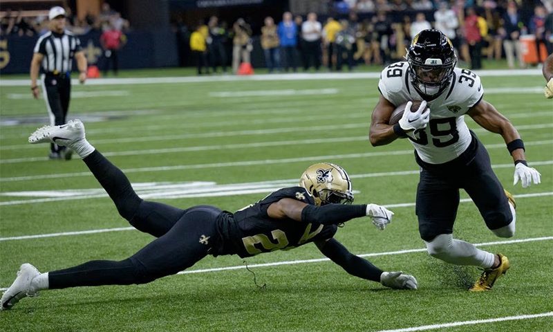 New Orleans, Louisiana, USA; Jacksonville Jaguars wide receiver Jamal Agnew (39) makes a gain after a reception against New Orleans Saints cornerback Paulson Adebo (29) during the first quarter at the Caesars Superdome. Mandatory Credit: Matthew Hinton-USA TODAY Sports