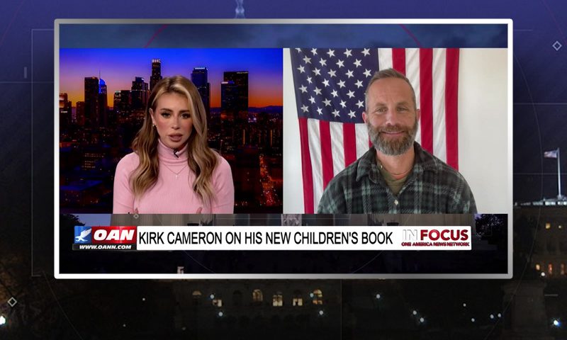 Video still from In Focus on One America News Network showing a split screen of the host on the left side, and on the right side is the guest, Kirk Cameron.