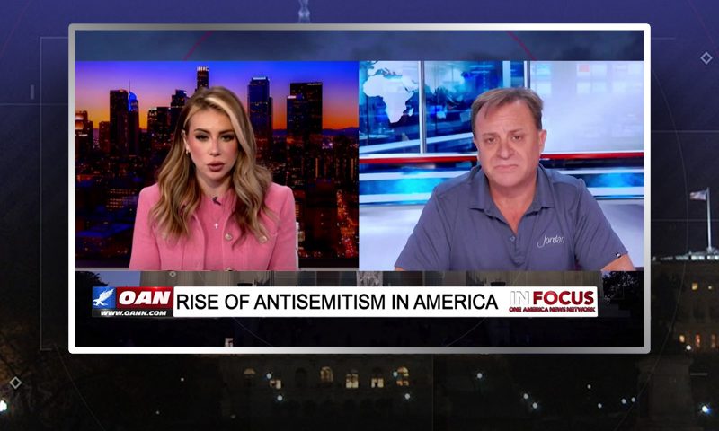 Video still from In Focus on One America News Network showing a split screen of the host on the left side, and on the right side is the guest, John Jordan.