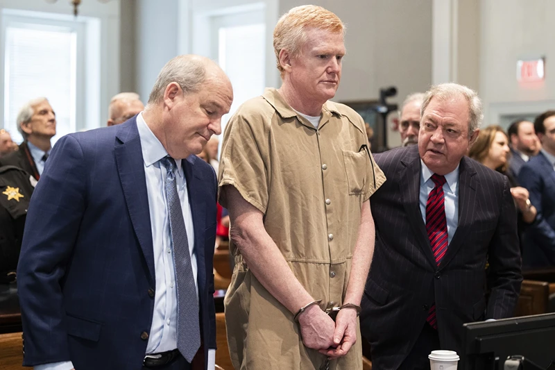  Alex Murdaugh speaks with his legal team before he is sentenced to two consecutive life sentences for the murder of his wife and son by Judge Clifton Newman at the Colleton County Courthouse on Friday, March 3, 2023 in in Walterboro, S.C. Murdaugh's lawyers have filed court papers that he plans to plead guilty in federal court to charges he stole money from clients. (Joshua Boucher/The State via AP, File, Pool)