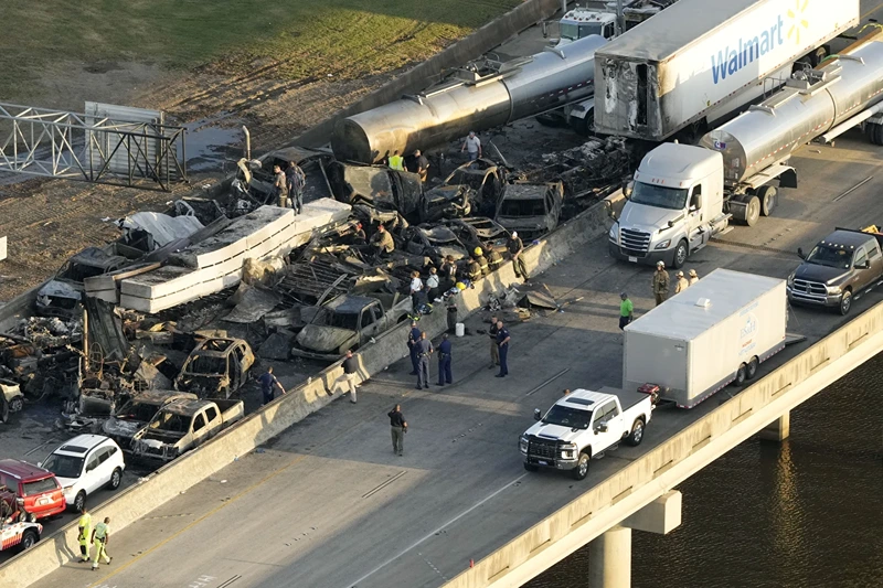 In this aerial photo, responders are seen near wreckage in the aftermath of a multi-vehicle pileup on I-55 in Manchac, La., Monday, Oct. 23, 2023. A 