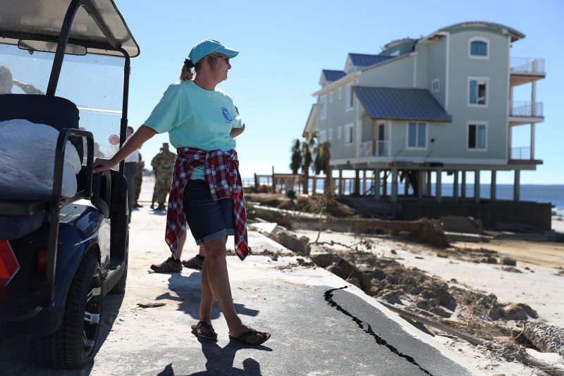 MEXICO BEACH, FL - OCTOBER 12:  Angel Smith stands next to a golf cart with some of the items she salvaged from her home that was damaged by Hurricane Michael on October 12, 2018 in Mexico Beach, Florida. Angel said, ' she never thought she would one day have all her belongings in two plastic bags'. The hurricane hit the panhandle area with category 4 winds causing major damage.  (Photo by Joe Raedle/Getty Images)