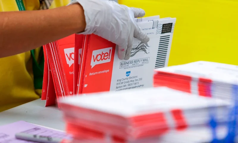 US-POLITICS-VOTE An election worker opens envelopes containing vote-by-mail ballots for the August 4 Washington state primary at King County Elections in Renton, Washington on August 3, 2020. (Photo by Jason Redmond / AFP) (Photo by JASON REDMOND/AFP via Getty Images)