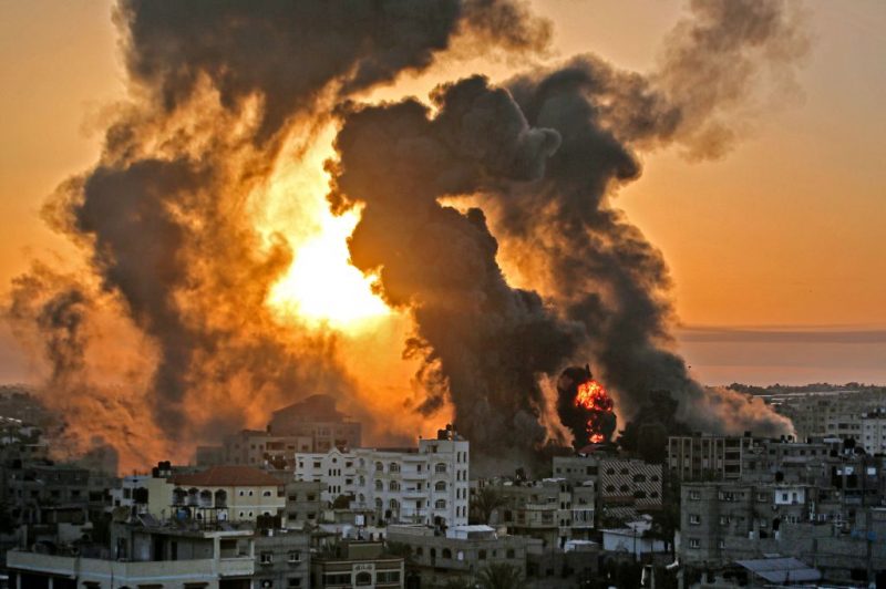 TOPSHOT - A fire rages at sunrise in Khan Yunish following an Israeli airstrike on targets in the southern Gaza strip, early on May 12, 2021. - Israeli air raids in the Gaza Strip have hit the homes of high-ranking members of the Hamas militant group, the military said Wednesday, with the territory's police headquarters also targeted. (Photo by YOUSSEF MASSOUD / AFP) (Photo by YOUSSEF MASSOUD/AFP via Getty Images)