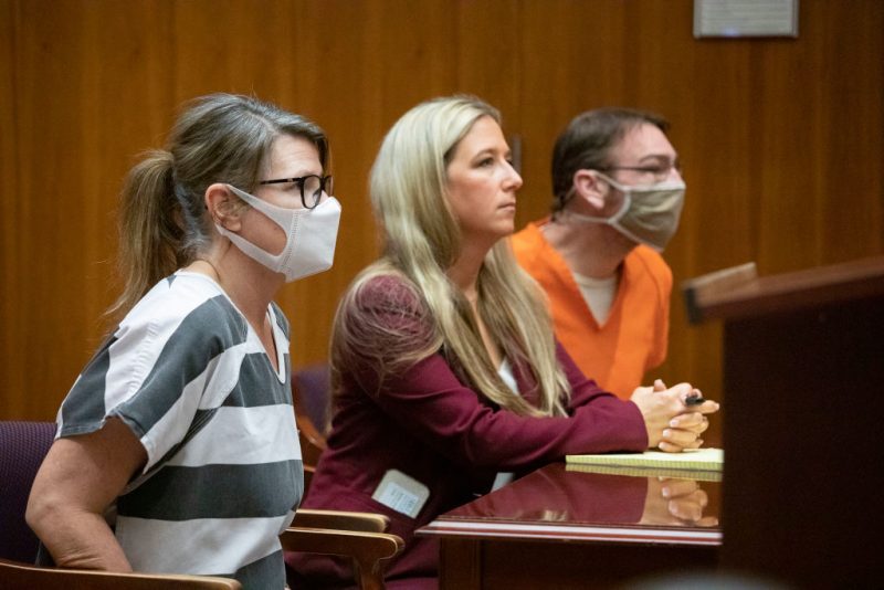 PONTIAC, MI - MARCH 22: Jennifer Crumbley (L) and her husband James Crumbley, parents of the alleged teen Oxford High School shooter Ethan Crumbley who is charged with killing four people and wounding seven others, appear in 6th Circuit Court for their pretrial hearing with James Crumbleys defense attorney Mariell Lehman (center) on March 22, 2022 in Pontiac, Michigan. Both parents are being charged with four counts of involuntary manslaughter. It is the first time in the U.S. that the parents of an alleged mass school shooter have been charged in connection with their child's alleged school shooting. (Photo by Bill Pugliano/Getty Images)