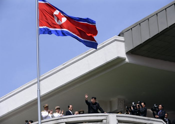 TOPSHOT - North Korea's leader Kim Jong-Un (C) waves at the end of a major military parade to mark 100 years since the birth of the country's founder and his grandfather, Kim Il-Sung, in Pyongyang on April 15, 2012. The commemorations came just two days after a satellite launch timed to mark the centenary fizzled out embarrassingly when the rocket apparently exploded within minutes of blastoff and plunged into the sea. AFP PHOTO / PEDRO UGARTE (Photo by Pedro UGARTE / AFP) (Photo by PEDRO UGARTE/AFP via Getty Images)