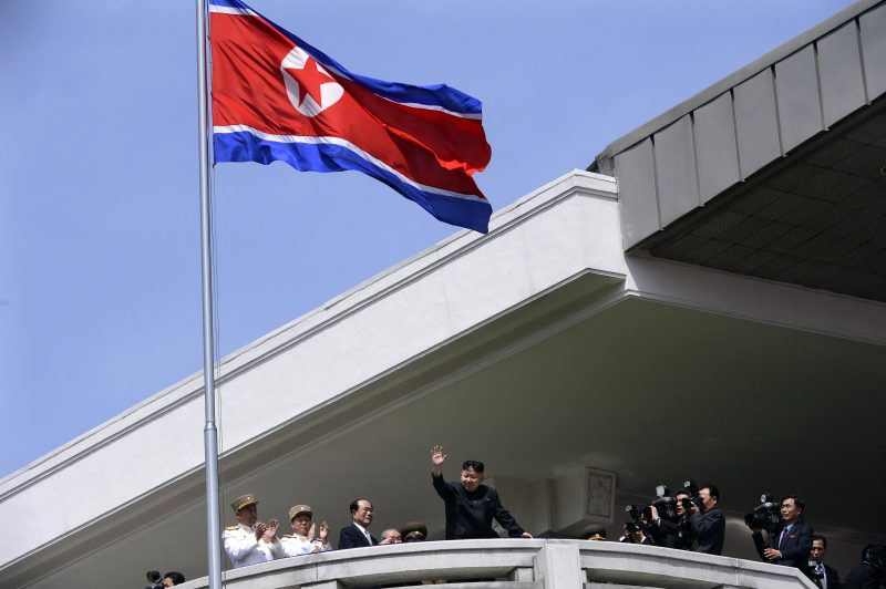TOPSHOT - North Korea's leader Kim Jong-Un (C) waves at the end of a major military parade to mark 100 years since the birth of the country's founder and his grandfather, Kim Il-Sung, in Pyongyang on April 15, 2012. The commemorations came just two days after a satellite launch timed to mark the centenary fizzled out embarrassingly when the rocket apparently exploded within minutes of blastoff and plunged into the sea.    AFP PHOTO / PEDRO UGARTE (Photo by Pedro UGARTE / AFP) (Photo by PEDRO UGARTE/AFP via Getty Images)