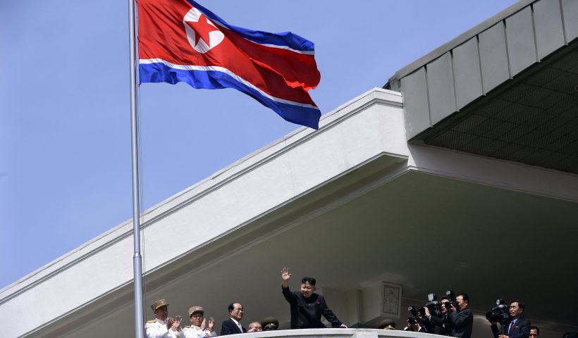 TOPSHOT - North Korea's leader Kim Jong-Un (C) waves at the end of a major military parade to mark 100 years since the birth of the country's founder and his grandfather, Kim Il-Sung, in Pyongyang on April 15, 2012. The commemorations came just two days after a satellite launch timed to mark the centenary fizzled out embarrassingly when the rocket apparently exploded within minutes of blastoff and plunged into the sea. AFP PHOTO / PEDRO UGARTE (Photo by Pedro UGARTE / AFP) (Photo by PEDRO UGARTE/AFP via Getty Images)
