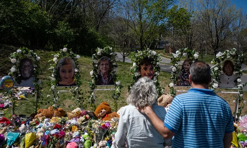 NASHVILLE, TN - APRIL 01: People visit a makeshift memorial at the entrance of The Covenant School on April 1, 2023 in Nashville, Tennessee. Three students and three adults were killed by the 28-year-old shooter on Monday. (Photo by Seth Herald/Getty Images)