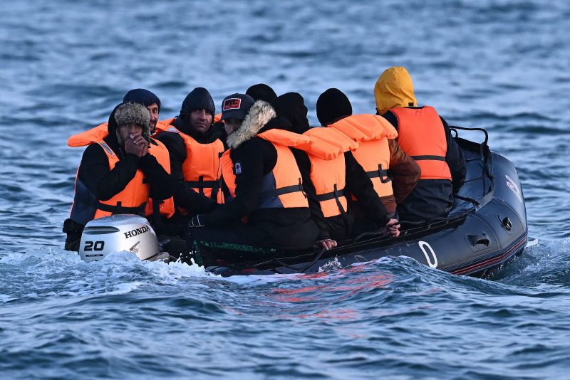TOPSHOT - Migrants travel in an inflatable boat across the English Channel, bound for Dover on the south coast of England. More than 45,000 migrants arrived in the UK last year by crossing the English Channel on small boats. (Photo by Ben Stansall / AFP) (Photo by BEN STANSALL/AFP via Getty Images)
