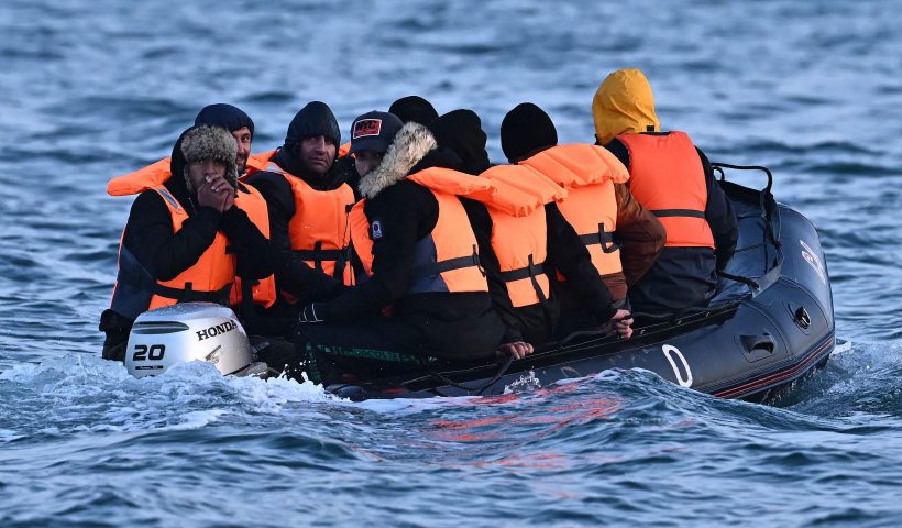 TOPSHOT - Migrants travel in an inflatable boat across the English Channel, bound for Dover on the south coast of England. More than 45,000 migrants arrived in the UK last year by crossing the English Channel on small boats. (Photo by Ben Stansall / AFP) (Photo by BEN STANSALL/AFP via Getty Images)