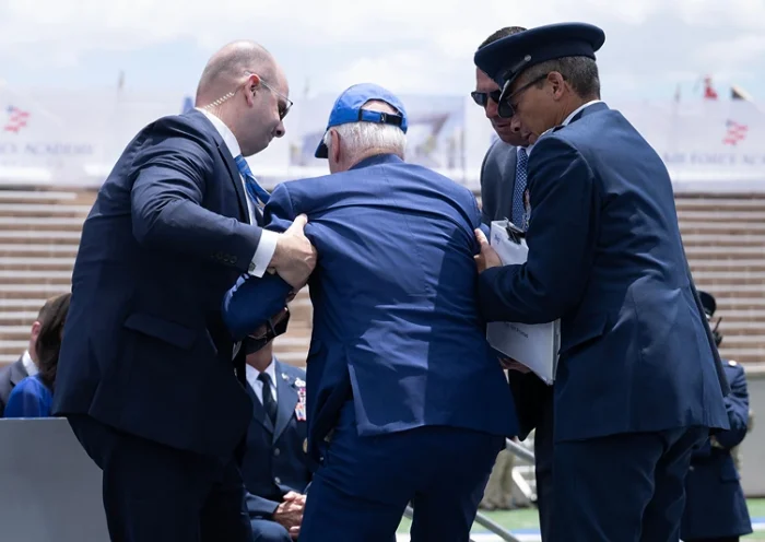 US President Joe Biden is helped up after falling during the graduation ceremony at the United States Air Force Academy, just north of Colorado Springs in El Paso County, Colorado, on June 1, 2023. (Photo by Brendan Smialowski / AFP) (Photo by BRENDAN SMIALOWSKI/AFP via Getty Images)