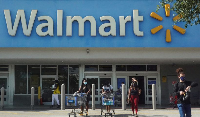 HALLANDALE BEACH, FLORIDA - MAY 18: People wearing protective masks walk from a Walmart store on May 18, 2021 in Hallandale Beach, Florida. Walmart announced that customers who are fully vaccinated against Covid-19 will not need to wear a mask in its stores, unless one is required by state or local laws. The announcement came after the Centers for Disease Control and Prevention said that fully vaccinated people do not need to wear a mask or stay 6 feet apart from others in most cases, whether indoors or outdoors. (Photo by Joe Raedle/Getty Images)