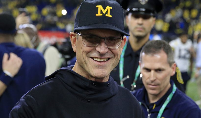 INDIANAPOLIS, INDIANA - DECEMBER 04: Head coach Jim Harbaugh of the Michigan Wolverines walks on the field after winning the Big Ten Football Championship game against the the Iowa Hawkeyes at Lucas Oil Stadium on December 04, 2021 in Indianapolis, Indiana. (Photo by Justin Casterline/Getty Images)