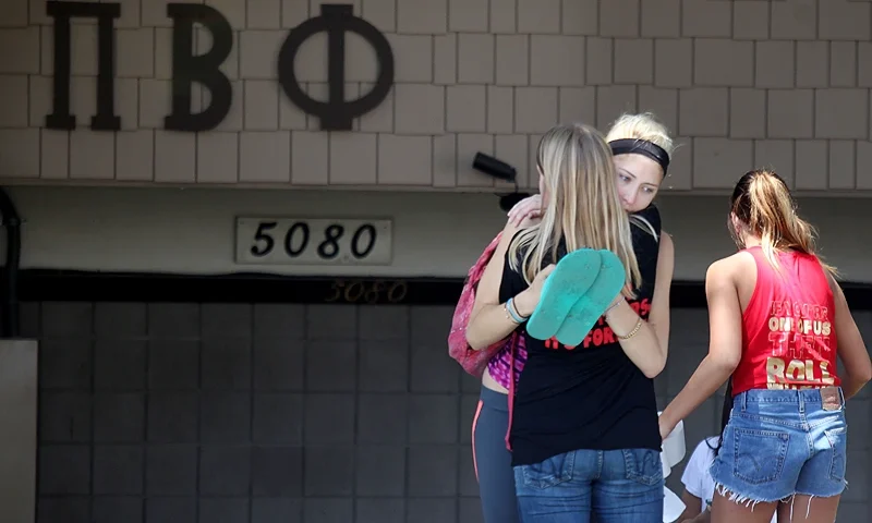 SAN DIEGO, CA - APRIL 20: Students console each other outside of the Pi Beta Phi Sorority near San Diego State University after news that a student had died at the Phi Kappa Theta Fraternity on campus April 20, 2012 in San Diego, California. The cause of death is still under investigation after the student was found dead around 8:30 am. (Photo by Sandy Huffaker/Getty Images)