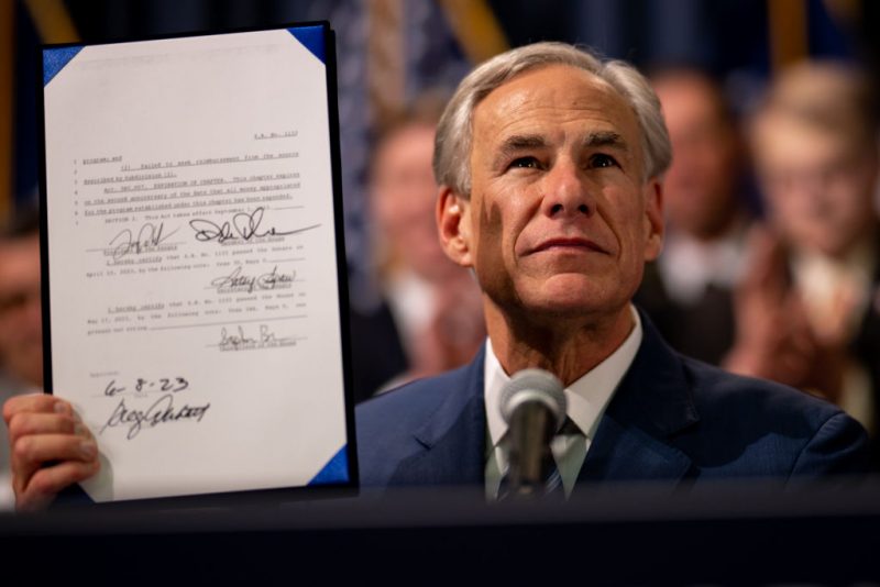 AUSTIN, TEXAS - JUNE 08: Texas Gov. Greg Abbott displays a bill he signed at a news conference at the state Capitol on June 08, 2023 in Austin, Texas. Abbott and Texas Department of Public Safety Director Steve McCraw joined bill authors, sponsors, legislators and law enforcement members in the signing of bills aimed at enhancing southern border security. (Photo by Brandon Bell/Getty Images)