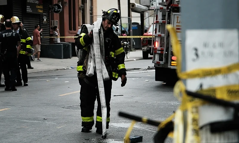 NEW YORK, NEW YORK - JUNE 20: Firefighters work outside a building in Chinatown after four people were killed by a fire in an e-bike repair shop overnight on June 20, 2023 in New York City. Lithium-ion e-bike batteries have caused numerous fires and fatalities in recent years due to the rising popularity of e-bikes for delivery purposes. New York City Mayor Eric Adams' administration has taken strong measures against unregulated e-bike and e-scooter batteries, which often present the highest risk when improperly charged. (Photo by Spencer Platt/Getty Images)