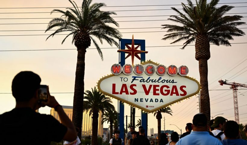 People take pictures with the Welcome To Fabulous Las Vegas sign under hazy orange skies as the sun sets in Las Vegas, Nevada on July 29, 2023. The National Weather Service said Saturday that the York Fire burning in the Mojave National Preserve is sending smoke into the Las Vegas Valley. (Photo by Patrick T. Fallon / AFP) (Photo by PATRICK T. FALLON/AFP via Getty Images)