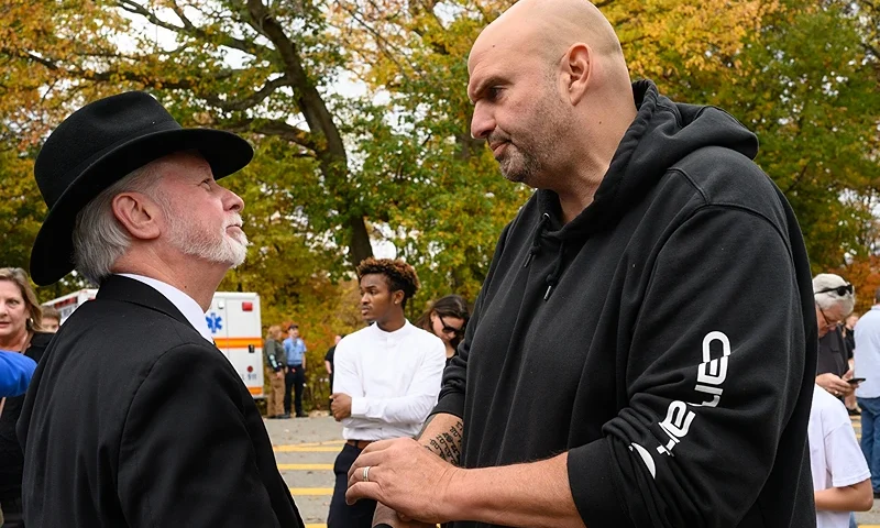 PITTSBURGH, PENNSYLVANIA - OCTOBER 27: Rabbi Jeffrey Myers of the Tree of Life synagogue, left, greets Pennsylvania Senator John Fetterman, right, at the Commemoration Ceremony on the fifth anniversary of the Tree of Life synagogue attack on October 27, 2023 in Pittsburgh, Pennsylvania. The shooting, the deadliest attack on Jews in U.S. history, left 11 dead after a gunman stormed a synagogue in Pittsburgh's Squirrel Hill neighborhood. (Photo by Justin Merriman/Getty Images)