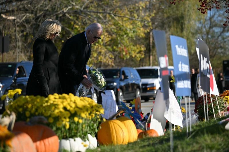 US President Joe Biden and First Lady Jill Biden pay their respects outside Schemengees Bar and Grille in Lewiston, Maine, on November 3, 2023 following a mass shooting on October 25. (Photo by Mandel NGAN / AFP) (Photo by MANDEL NGAN/AFP via Getty Images)