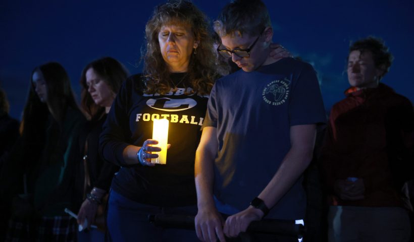 LISBON, MAINE - OCTOBER 28: Julie Moore and her son Dylan Moore attend a candlelight vigil to honor the victims of the Lewiston shootings on October 28, 2023 in Lisbon, Maine. Robert Card killed 18 people in a mass shooting at a bowling alley and a restaurant in Lewiston and was found dead in Lisbon. (Photo by Joe Raedle/Getty Images)