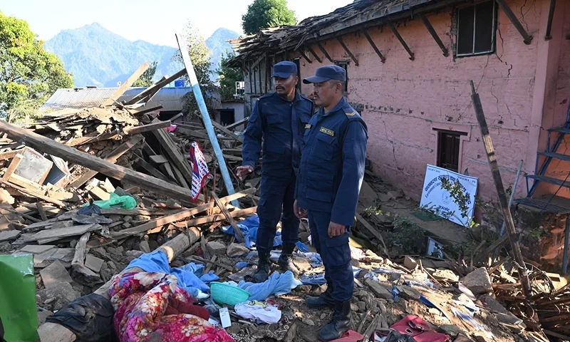 NEPAL-EARTHQUAKE Nepali policemen inspect the rubble of houses in Jajarkot district on November 4, 2023, following an overnight a 5.6-magnitude earthquake. At least 132 people were killed in an overnight earthquake of 5.6-magnitude that struck a remote pocket of Nepal, officials said on November 4, as security forces rushed to assist with rescue efforts. (Photo by PRAKASH MATHEMA / AFP) (Photo by PRAKASH MATHEMA/AFP via Getty Images)