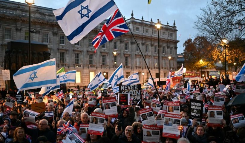 Protesters wave Israeli flags and hold photos of people held hostage by Palestinian militant group Hamas in Gaza, during a demonstration outside Downing Street on November 19, 2023 to protest against antisemitism and to call for the release of the hostages. (Photo by JUSTIN TALLIS / AFP) (Photo by JUSTIN TALLIS/AFP via Getty Images)