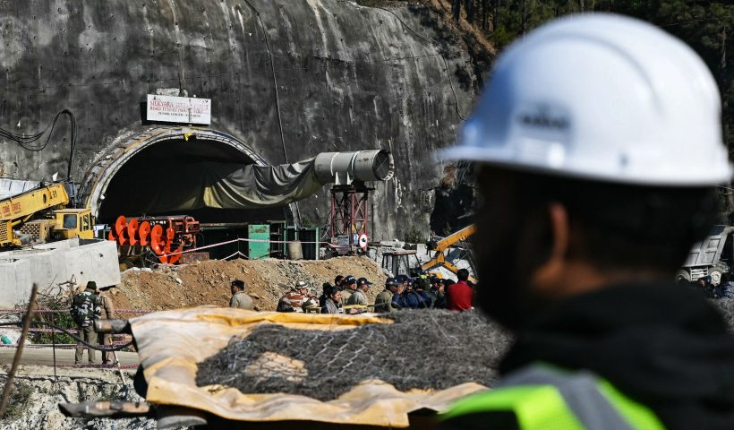 TOPSHOT - A rescue personnel stands near an entrance of the Silkyara under construction road tunnel, during the final phase of a rescue operation, days after a portion of it collapsed in the Uttarkashi district of India's Uttarakhand state on November 23, 2023. Ambulances were on standby on November 23 morning, as Indian rescuers dug through the final metres of debris separating them from 41 workers trapped in a collapsed road tunnel for nearly two weeks. (Photo by Arun SANKAR / AFP) (Photo by ARUN SANKAR/AFP via Getty Images)