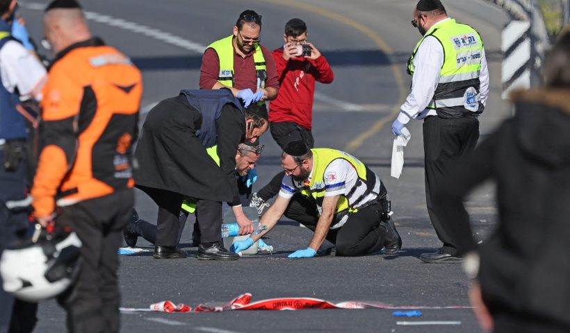 TOPSHOT - Israeli rescue teams in spect the scene of a shooting attack in Jerusalem on November 30, 2023. Gunmen killed three people and wounded several more in Jerusalem on Thursday, Israeli police said, in an attack shortly after an truce in the Israel-Hamas war was extended. Police said two suspects "implicated in the shootings were neutralised on the spot" after the attack near a bus stop on the western side of Jerusalem, where there are no checkpoints guarding entrance to the city. (Photo by AHMAD GHARABLI / AFP) (Photo by AHMAD GHARABLI/AFP via Getty Images)
