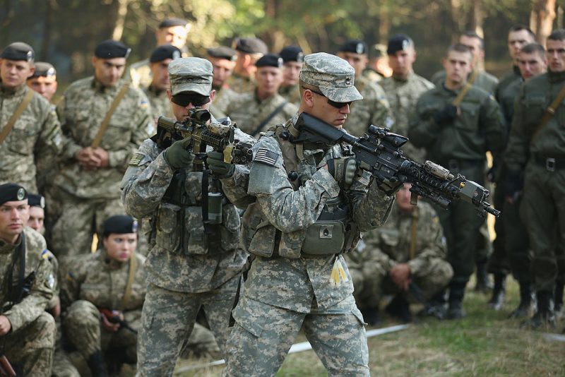 YAVOROV, UKRAINE - SEPTEMBER 16: Members of the U.S. Army 173rd Airborne Brigade demonstrate urban warfare techniques as Ukrainian soldiers look on on the second day of the 'Rapid Trident' bilateral military exercises between the United States and Ukraine that include troops from a variety of NATO and non-NATO countries on September 16, 2014 near Yavorov, Ukraine. The two-week exercises include participating units from a variety of NATO and NATO-associate countries as well as Ukrainian troops. Meanwhile the Ukrainian parliement today ratified an associate agreement with the European Union and also agreed on a autonomous status for the separatist-controlled portion of eatern Ukraine. (Photo by Sean Gallup/Getty Images)