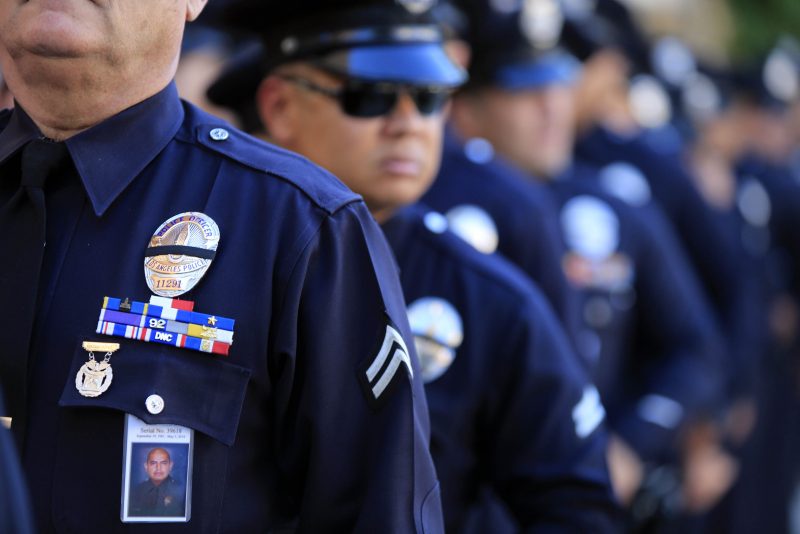LOS ANGELES, CA - MAY 14: LAPD officers wear a badge honoring fallen officer Roberto Sanchez during a memorial service at the Cathedral of Our Lady Of Angels May 14, 2014 in Los Angeles, California. Family and fellow officers paid their last respects to Sanchez who was killed while on duty when an SUV crashed into his patrol car on May 3rd in the Harbor City. (Photo by Mark Boster-Pool/Getty Images)