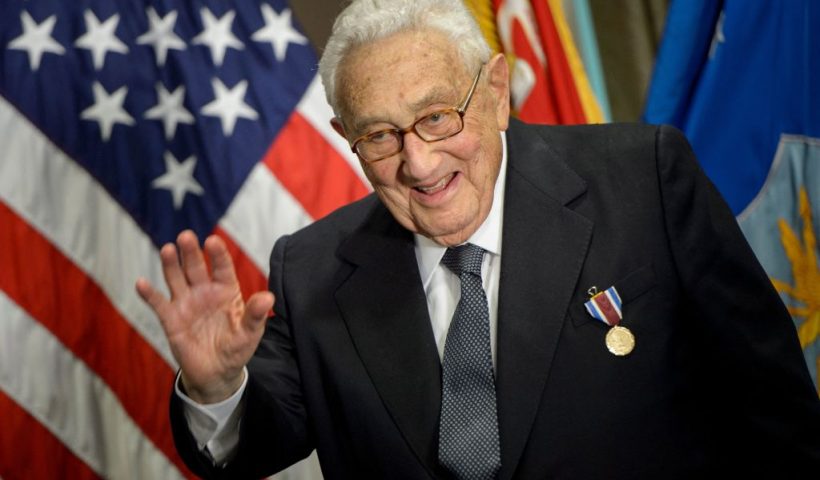 Former US Secretary of State Henry Kissinger waves after receiving an award during a ceremony at the Pentagon honoring his diplomatic career May 9, 2016 in Washington, DC. (Photo by Brendan Smialowski / AFP) (Photo by BRENDAN SMIALOWSKI/AFP via Getty Images)
