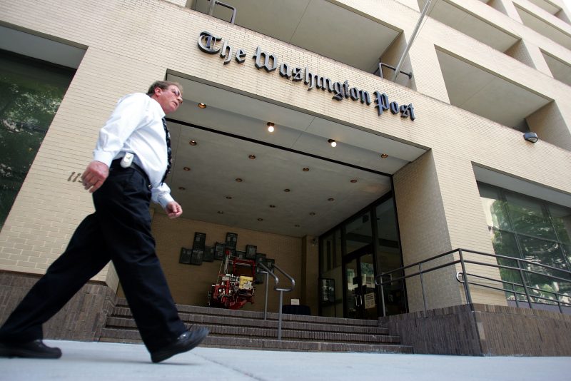 WASHINGTON - MAY 31: A man walks past The Washington Post building May 31, 2005 in Washington, DC. The current edition of Vanity Fair reports that retired FBI official Mark Felt was the "Deep Throat" source who spoke to two Washington Post reporters about the Watergate scandal that forced President Richard Nixon to resign in 1974.  (Photo by Joe Raedle/Getty Images)