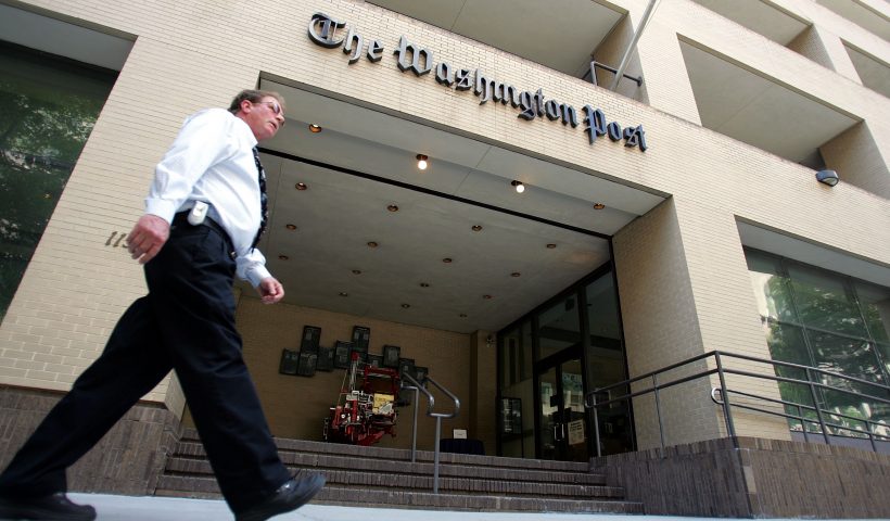 WASHINGTON - MAY 31: A man walks past The Washington Post building May 31, 2005 in Washington, DC. The current edition of Vanity Fair reports that retired FBI official Mark Felt was the "Deep Throat" source who spoke to two Washington Post reporters about the Watergate scandal that forced President Richard Nixon to resign in 1974. (Photo by Joe Raedle/Getty Images)