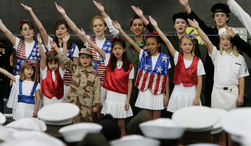 Military Personnel Sworn In As Citizens Aboard USS Midway On Veterans Day SAN DIEGO, CA - NOVEMBER11: Children from Celebration USA, Catch the Spirit Singers, perform during a military naturalization ceremony for U.S. Navy Sailors and U.S. Marines aboard the USS Midway November 11, 2005 in San Diego, California. More than 100 military personel from 48 countries became citizens during the naturalization ceremony. (Photo by Sandy Huffaker/Getty Images)