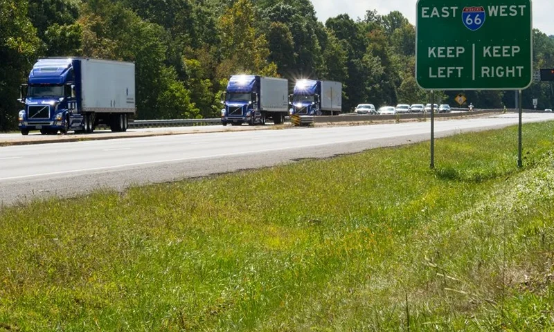 The US Federal Highway Administration conducts demonstrations of partially automated semi-truck platoons September 14, 2017, as three specially equiped Volvo semi-trucks cruise in Centreville, Virginia, with a Virginia State Trooper escort.