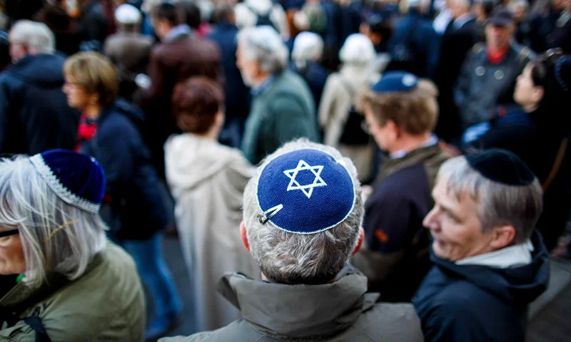BERLIN, GERMANY - APRIL 25: Participants wearing a kippah during a "wear a kippah" gathering to protest against anti-Semitism in front of the Jewish Community House on April 25, 2018 in Berlin, Germany. The Jewish community made a public appeal for Jews and non-Jews to attend the event and wear a kippah as a show of solidarity. The effort was sparked by a recent incident in Berlin in which a Syrian Palestinian man berated and struck with his belt a man wearing a kippah. The kippah-wearer was not Jewish, but an Israeli Arab who wore the kippah curious what reaction he might receive while walking in Berlin. In 2017 Germany reportedly recorded 1453 criminal offenses related to anti-Semitism, of which 94 percent were attributed to German citizens. (Photo by Carsten Koall/Getty Images)