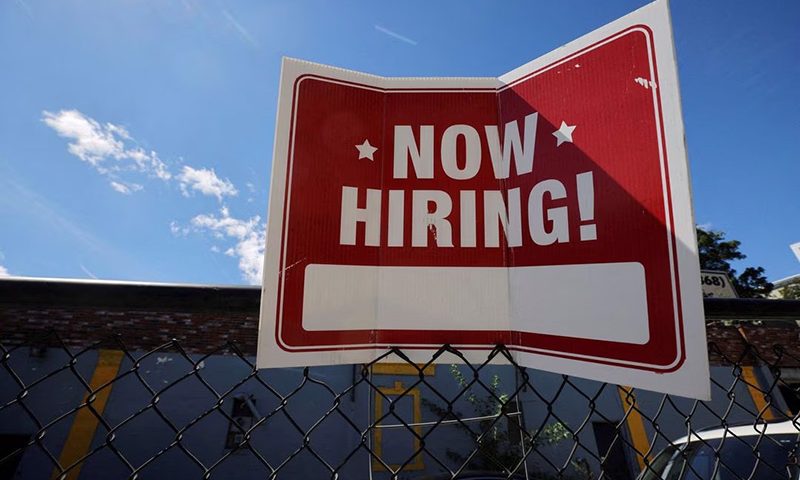 A "now hiring" sign is displayed outside Taylor Party and Equipment Rentals in Somerville, Massachusetts, U.S., September 1, 2022. REUTERS/Brian Snyder/File Photo