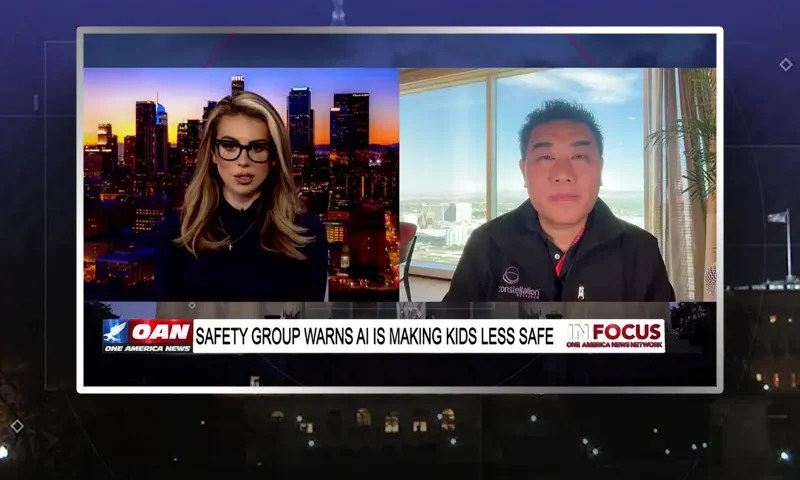 Video still from In Focus on One America News Network showing a split screen of the host on the left side, and on the right side is the guest, Ray Wang.