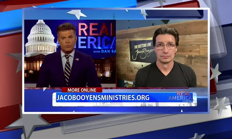 Video still from Real America on One America News Network showing a split screen of the host on the left side, and on the right side is the guest, Jaco Booyens.