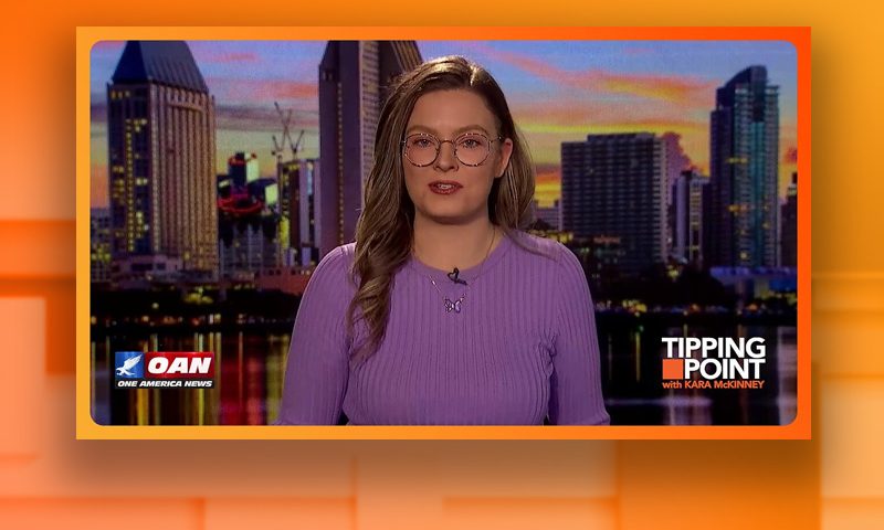 Video still of the host of Tipping Point at the desk of their talk show on One America News Network.