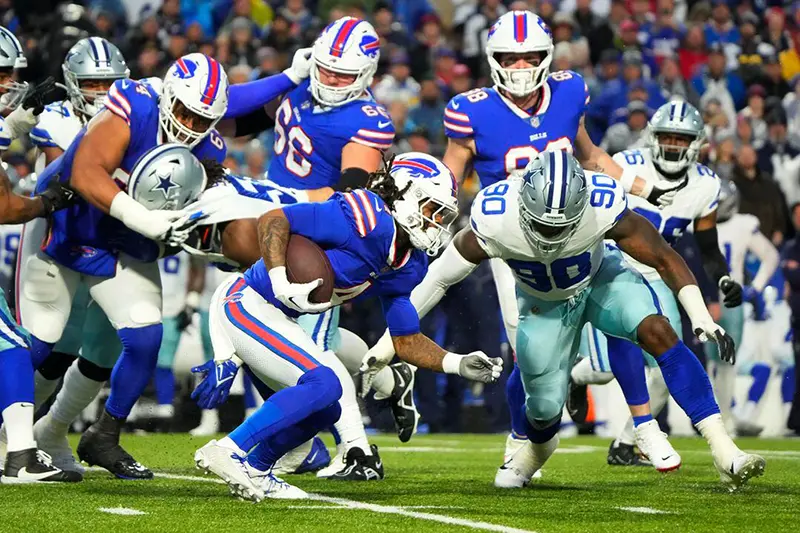 Buffalo Bills running back James Cook (4) is tackled by Dallas Cowboys defensive end DeMarcus Lawrence (90) in the first half at Highmark Stadium. Mandatory Credit: Gregory Fisher-USA TODAY Sports
