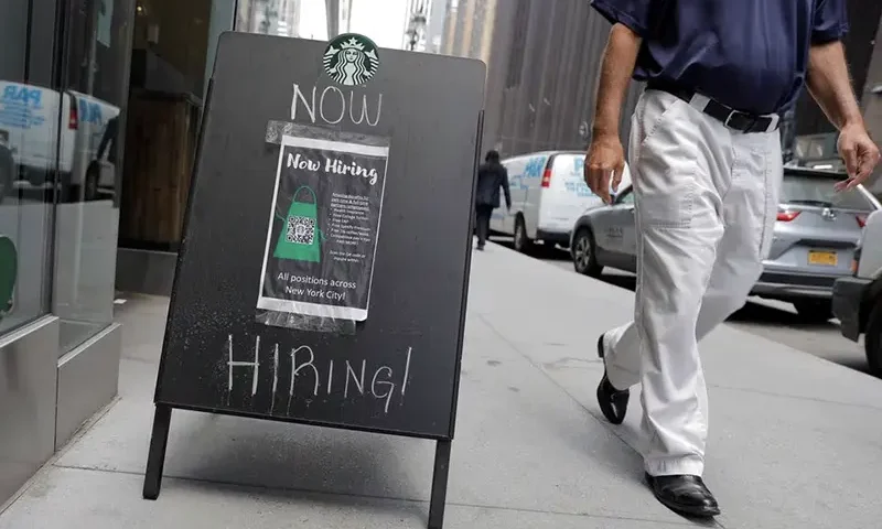 A sign advertising job openings is seen outside of a Starbucks in Manhattan, New York City, New York, U.S., May 26, 2021. REUTERS/Andrew Kelly/File Photo