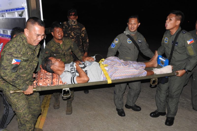 A wounded victim of the explosion inside the catholic cathedral is carried to a military plane in Jolo town, sulu province, in southern island of Mindanao on January 28, 2019, to be airlifted to nearby city of Zamboanga for treatment, a day after two explosions tore through the cathedral. - Investigators probing the Catholic cathedral bombing that killed 21 people in the Philippines' restive south said January 28, a group tied to notorious Islamists Abu Sayyaf is the prime suspect. (Photo by NICKEE BUTLANGAN / AFP)        (Photo credit should read NICKEE BUTLANGAN/AFP via Getty Images)