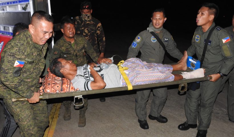 A wounded victim of the explosion inside the catholic cathedral is carried to a military plane in Jolo town, sulu province, in southern island of Mindanao on January 28, 2019, to be airlifted to nearby city of Zamboanga for treatment, a day after two explosions tore through the cathedral. - Investigators probing the Catholic cathedral bombing that killed 21 people in the Philippines' restive south said January 28, a group tied to notorious Islamists Abu Sayyaf is the prime suspect. (Photo by NICKEE BUTLANGAN / AFP) (Photo credit should read NICKEE BUTLANGAN/AFP via Getty Images)