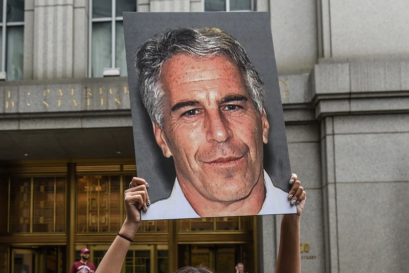 Jeffrey Epstein Appears In Manhattan Federal Court On Sex Trafficking Charges
NEW YORK, NY - JULY 08: A protest group called "Hot Mess" hold up signs of Jeffrey Epstein in front of the federal courthouse on July 8, 2019 in New York City. According to reports, Epstein will be charged with one count of sex trafficking of minors and one count of conspiracy to engage in sex trafficking of minors. (Photo by Stephanie Keith/Getty Images)